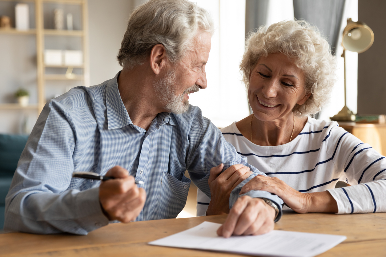 70s couple discuss agreement ready to sign contract